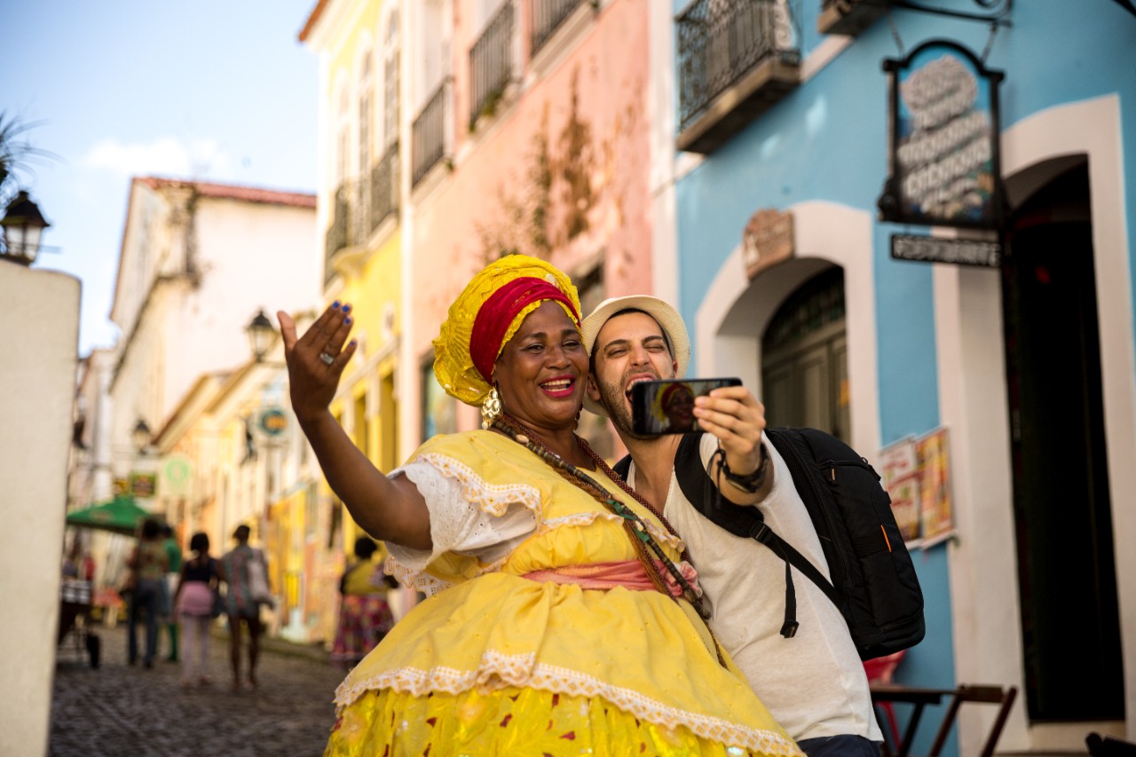 A tourist takes photo with a Cuban woman