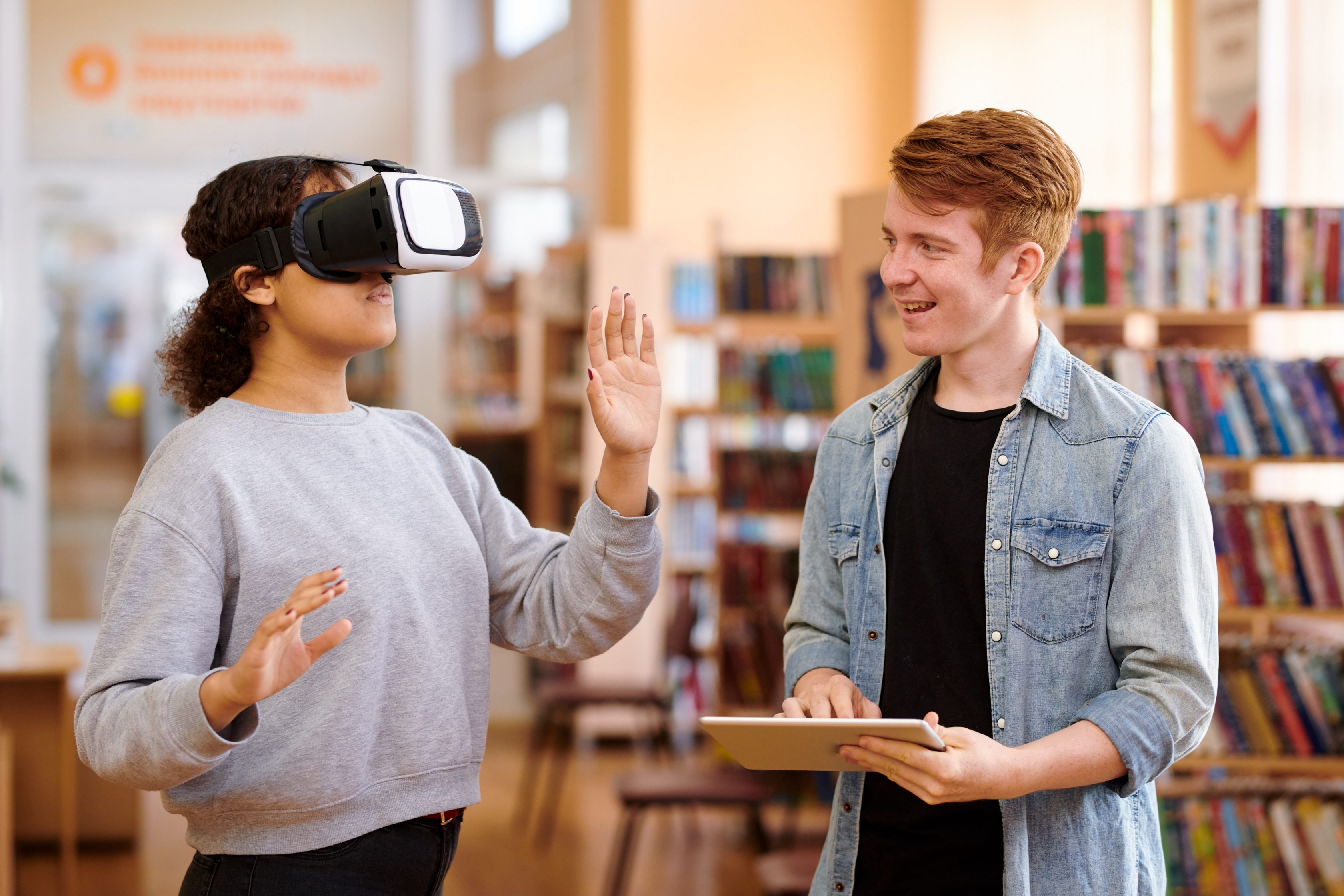 students with tablet are interacting with vr headset