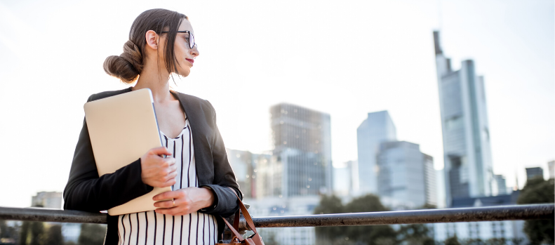 Business woman with laptop outdoors
